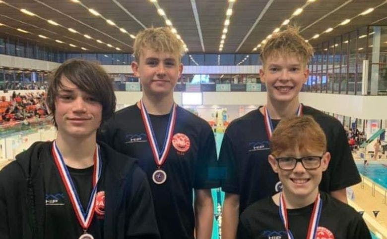 A group of swimmers with their medals after the East District Age Group Championships